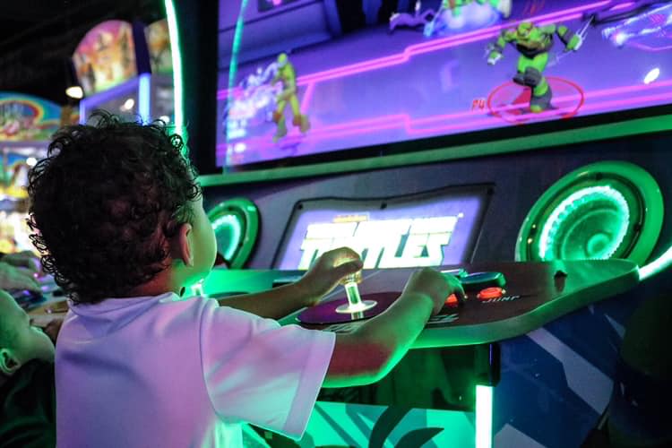 child playing an arcade game